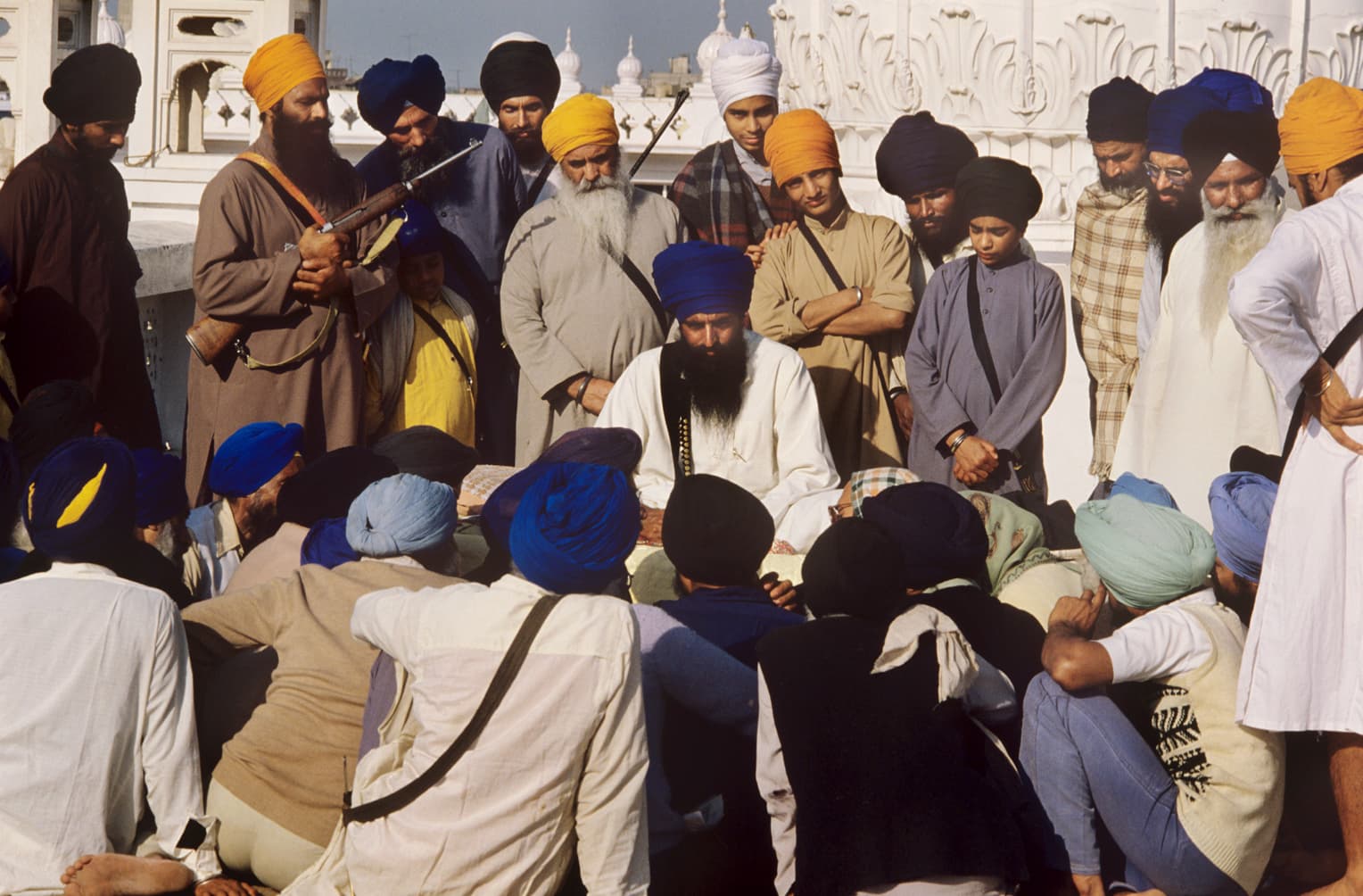 “Jarnail Singh Bhindranwale (center sitting) with armed Sikh militants in the Golden Temple, a few days before the Indian army stormed the complex killing him and the majority of his followers. Amritsar, Punjub, May 1984. Photo taken by Raghu Rai.”